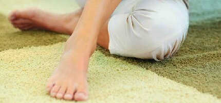 Realiza masajes en tus pies todas las noches Pies relajados sobre una alfombra